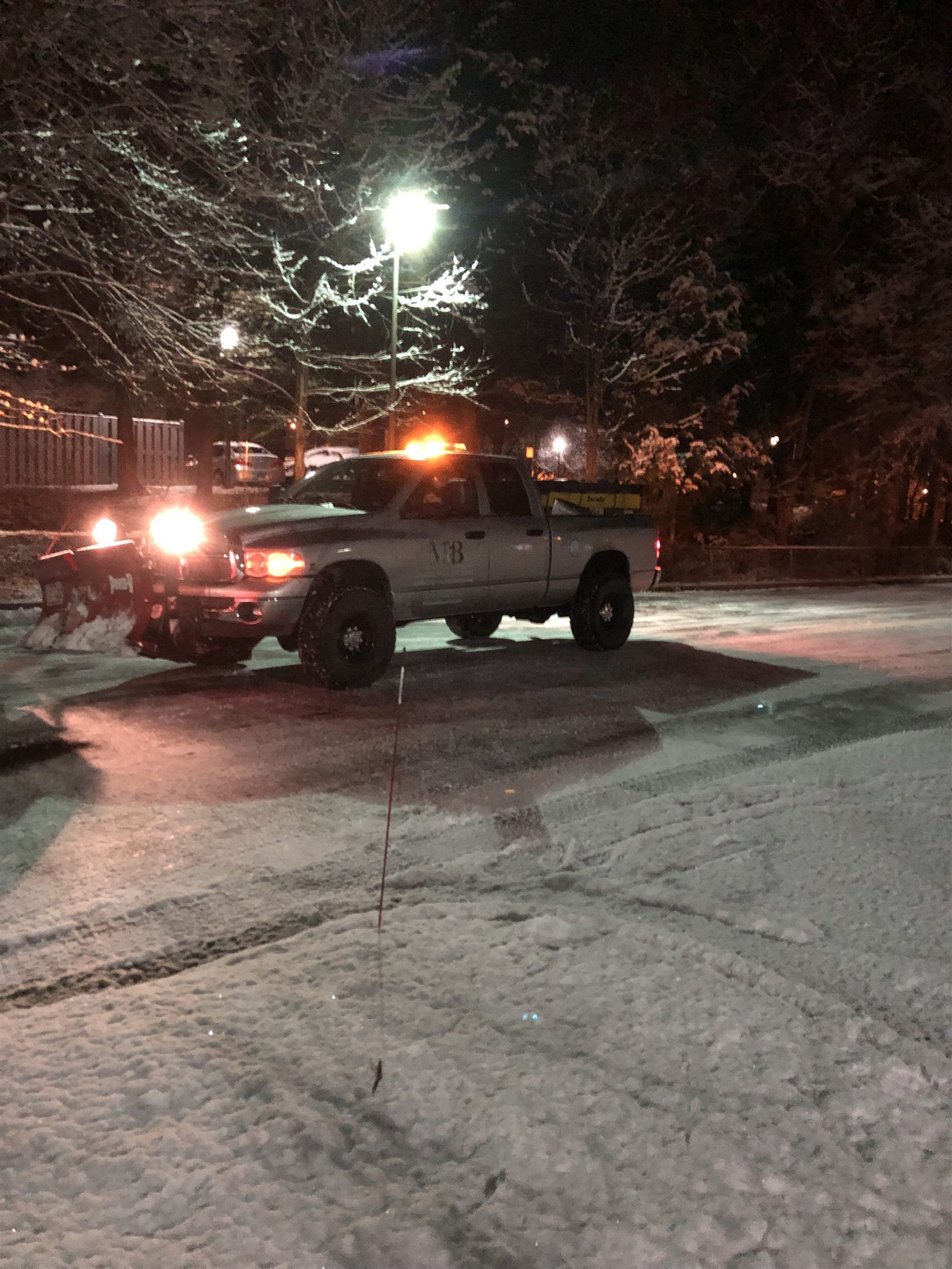 MB Homestead Services truck plowing snow at night
